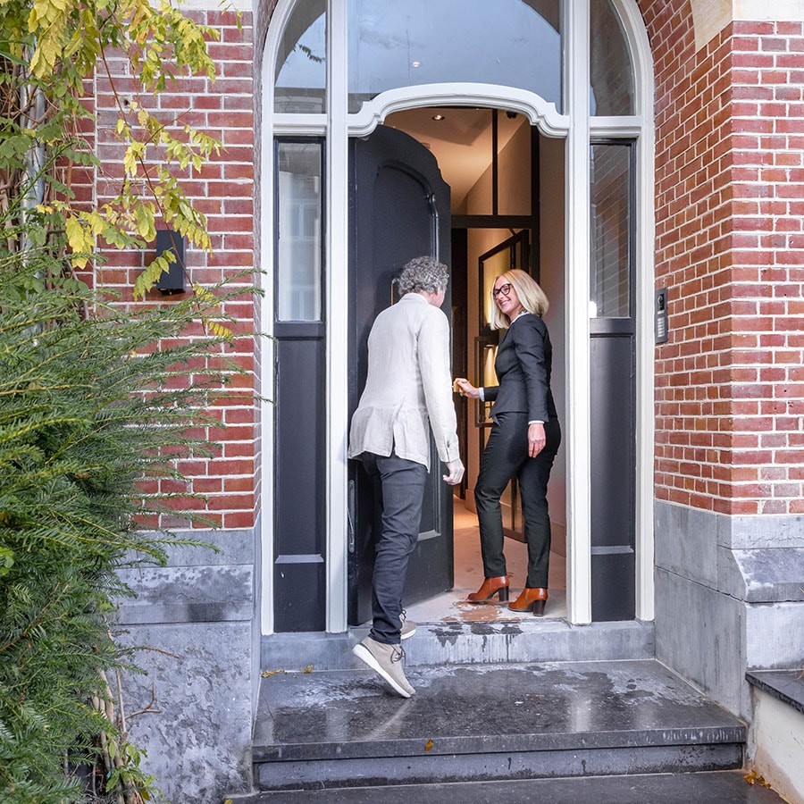 Estate agent welcoming a client at the front door