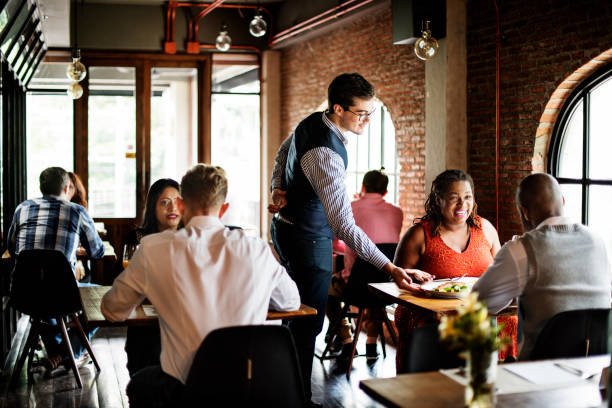 Waiter serving guests in a busy restaurant